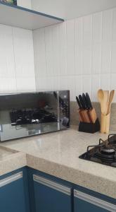 a kitchen with a stove and a counter top at Casa De Valentina in Tiradentes