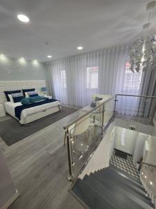 a large bedroom with a bed and a glass railing at My way in Azores in Horta