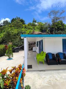 a porch of a house with a blue roof at Finca en Vergara "Prado Alto" in Vergara +8 photos
