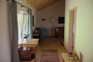 a living room with a table and a window at Chesa Clavazzin in Brunnadern +17 photos