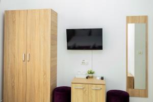 a room with a flat screen tv on a wall at MARCONI GUESTHOUSE in Hunedoara