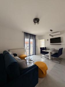 a living room with a couch and a table at Apartments Ostojic in Krk