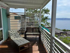 a porch with two chairs and a bench on it at Adriastay 360 in Klenovica