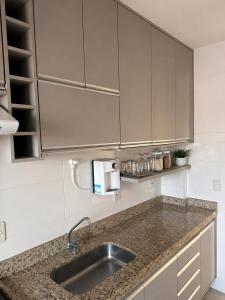 a kitchen with a sink and a counter top at Lisboa Hospedaria 300 m da praia do forte in Cabo Frio +2 photos