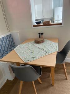 a wooden table with two chairs and a table cloth on it at 31 Sailsbury road in Marlborough +3 photos