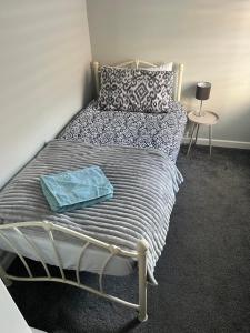 a bedroom with a bed with a blue towel on it at 31 Sailsbury road in Marlborough