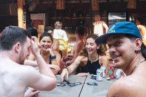 a group of people sitting at a table at Viajero Puerto Escondido Hostel in Puerto Escondido