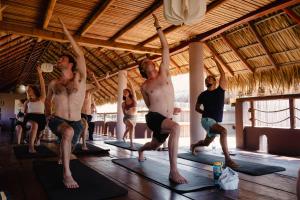 a group of people in a yoga class at Viajero Puerto Escondido Hostel in Puerto Escondido