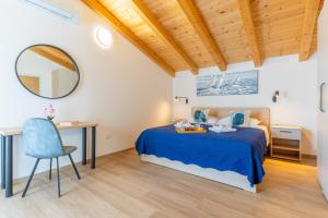a bedroom with a bed and a desk and a mirror at Villa Lareva - sunset view in Ustrine +47 photos