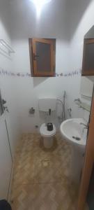 a bathroom with a white toilet and a sink at Bissau Residence in Bissau