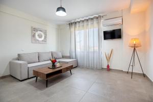 a living room with a couch and a table at House Rytha in Limenaria