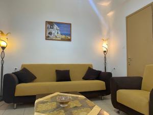 a living room with a couch and a table at Ravanos Apartment in Loutraki
