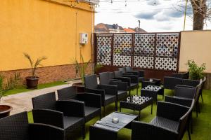 a row of chairs and tables on a patio at MARCONI GUESTHOUSE in Hunedoara