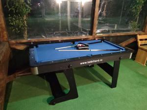 a pool table in a room with a window at Casa Galeata in Nehoiu