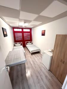 a room with two beds and a refrigerator at Monteurunterkunft Schlierbach in Schlierbach