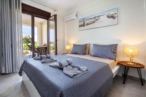 a bedroom with a bed with towels on it at House Rytha in Limenaria