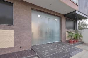 a large glass door on the side of a building at Super Townhouse HOTEL SPR ROAD in Gurgaon