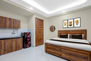 a bedroom with a large bed and a refrigerator at Super Townhouse HOTEL SPR ROAD in Gurgaon +47 photos