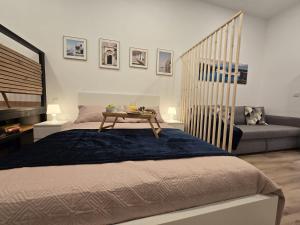 a bedroom with a bed with a table and a couch at Loft Centrico Tantín RH 17 in Santander