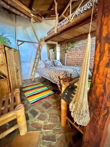 a room with a hammock in a house at Hotel Casa Tarzan San Agustin in San Agustín