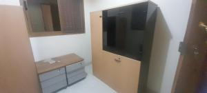 a bathroom with a sink and a large television at Bissau Residence in Bissau