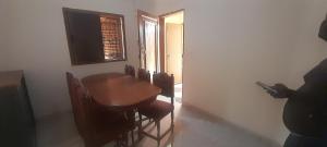 a dining room with a wooden table and chairs at Bissau Residence in Bissau