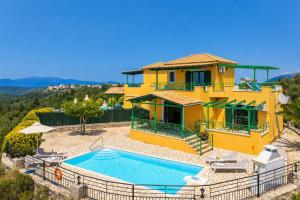 a yellow house with a swimming pool in front of it at Villa Vera in Dhrapanítika