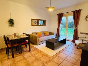 a living room with a table and a couch at Le Vercors Park in Die