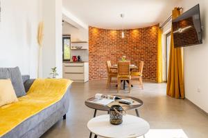 a living room with a couch and a table at Villa Lareva - sunset view in Ustrine