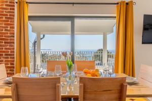 a dining room with a table and a large window at Villa Lareva - sunset view in Ustrine