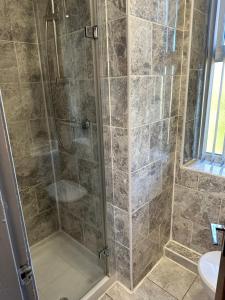 a shower with a glass door in a bathroom at Park hotel in Bradford
