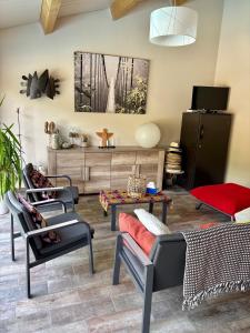 a living room with two chairs and a couch at Des roulottes en Provence in Barbentane