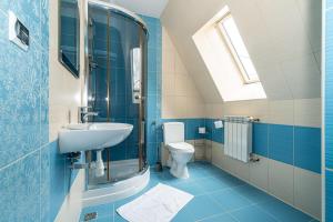 a blue bathroom with a sink and a toilet at Pokoje gościnne u Eli i Jacka in Murzasichle +71 photos