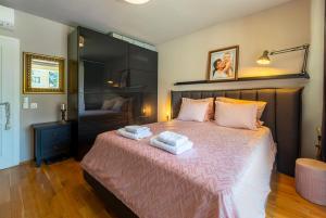 a bedroom with a bed with two towels on it at Les Faberges in Carpe Vita in Varna City +14 photos
