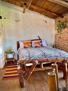 a bedroom with a wooden bed with pillows on it at Hotel Casa Tarzan San Agustin in San Agustín