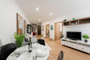 a living room with a dining table and a television at Centrum Kosice Apartment 60m2 4 beds in Košice +20 photos