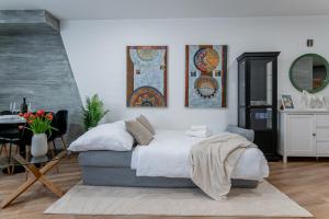 a bedroom with a bed and some pictures on the wall at Centrum Kosice Apartment 60m2 4 beds in Košice