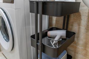 a black holder next to a washing machine at Centrum Kosice Apartment 60m2 4 beds in Košice