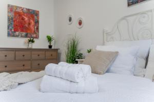 a pile of towels sitting on top of a bed at Centrum Kosice Apartment 60m2 4 beds in Košice