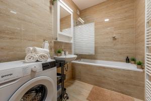 a laundry room with a washing machine and a sink at Centrum Kosice Apartment 60m2 4 beds in Košice
