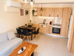 a kitchen and living room with a couch and a table at Joannas Luxury Apartment in Corfu