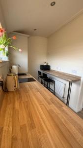 a large room with a wooden floor and a table at Hillhouse Coastal Escapes - PODs in Donegal