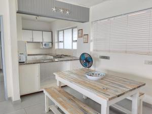 a kitchen with a wooden table with a bowl on it at Stella Maris 123 in Amanzimtoti