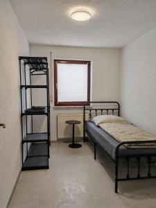 a bedroom with a bunk bed and a window at Ferienwohnung Unterkunft 24 in Aldingen +6 photos