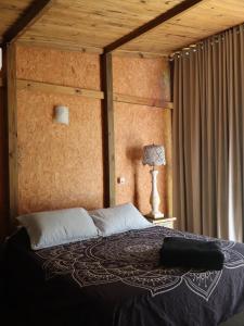 a bedroom with a large bed with a wooden ceiling at Suites Guarda do Embau in Palhoça +44 photos