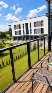 a balcony with a bench and a building at Apartment Ainiai in Panevėžys