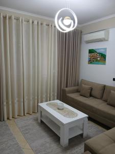 a living room with a couch and a coffee table at Nik's Cozy Apartment in Berat