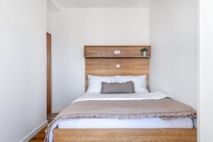 a bedroom with a large bed with a wooden headboard at Apartments Tihi in Vodice +78 photos