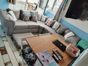 a living room with a couch and a table at ElE G Holiday let's Bridlington in Bridlington