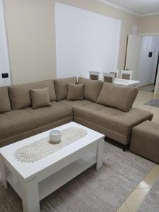 a living room with a couch and a coffee table at Nik's Cozy Apartment in Berat